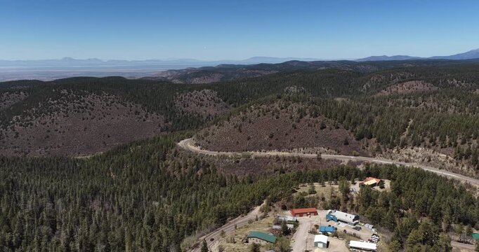 Aerial of mountain pass and buildings in Cloudcroft New Mexico sunny spring day