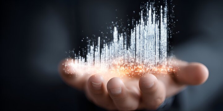 A hand presents a glowing, abstract cityscape formed by light particles suggesting technology, innovation, and the future of urban development.