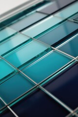 Obraz premium Glass tiles grid with teal and blue reflective surfaces and modern metal lines