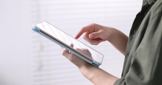 Teenage boy using tablet at home, closeup