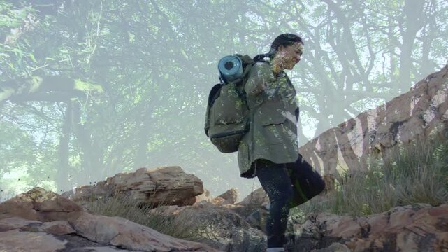 Vertical video: Stepping down ledge hiker climbing slope for balance in jacket with blue-mat pack