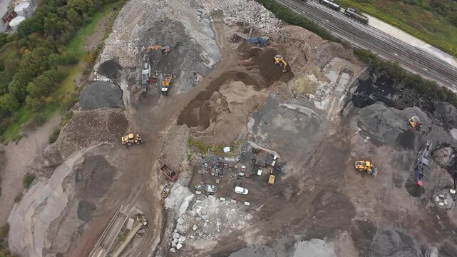 Aerial Redevelopment Site Beside Railway With Surveyors Mapping Contours And Excavators Leveling Ground, Brownfield Reclamation, Drainage Channels And Graded Terraces, Nearby Riverbank