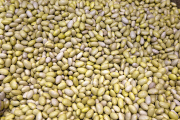 Fototapeta premium Raw green mung beans scattered as full-frame texture, food ingredient, healthy nutrition, organic grain, natural background.