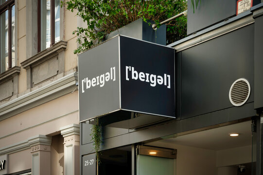 Cologne, Germany April 8 2026: Minimalist black cube sign for a bagel shop in Cologne's trendy Ehrenstrasse, featuring the name in phonetic spelling.