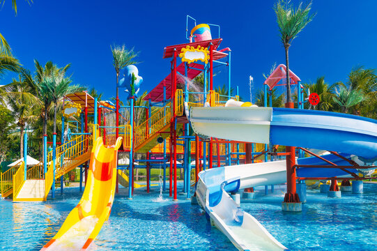 kids water park in the pool at the resort on summer vacation. Colorful aquapark with slides for children in pool