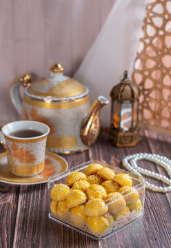 Indonesian Pineapple Tart Cookies (Nastar) in Transparent Box with Tea Set and Ramadan Decoration on Wooden Background