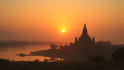 Fototapeta premium ziggurat. Ziggurat temple silhouette at sunset by a riverbank in misty atmosphere. inspiring travel planning, event programs, designed for cultural heritage projects and event programs.
