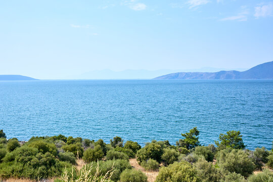 Scenic view of tranquil blue Lake Bafa with distant mountains and greenery