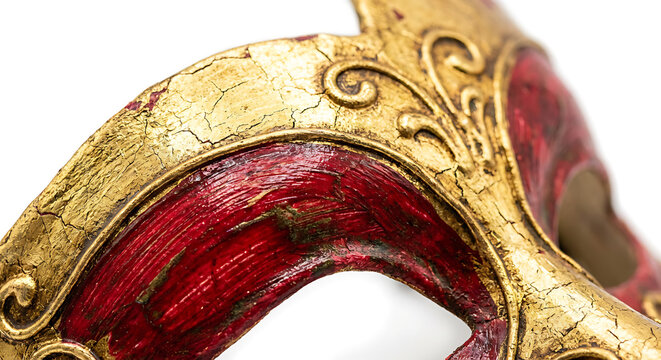 Ornate gold and red Venetian carnival mask close-up on white