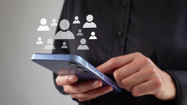 Female corporate leader using her cell phone with an animation highlighting different avatars of people, a concept for recruitment.