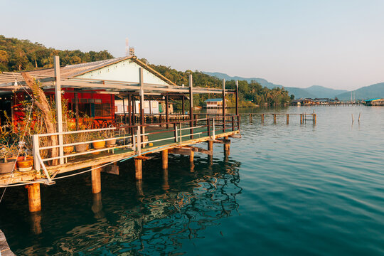 Waterfront wooden stilt houses and homestay over clear tropical sea.