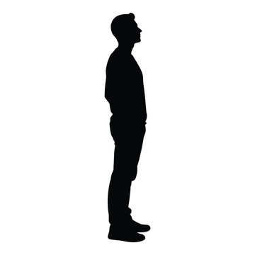 A full body silhouette of a man standing with his hands in his pockets and looking to the side with a neutral expression presented on a white background vector on white background