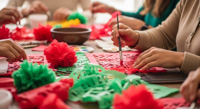 Hands crafting red and green paper pom-poms during Mexican Independence Day celebration, colorful folk art, festive atmosphere
