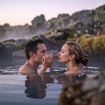 Romantic couple in a geothermal hot spring, enjoying a relaxing and intimate moment together.