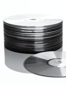 Stack of blank CDs and DVDs on a white background, ready for data storage and media burning.