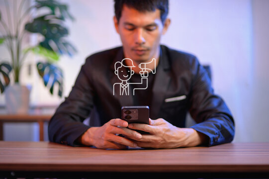 Businessman using smartphone with megaphone illustration above him