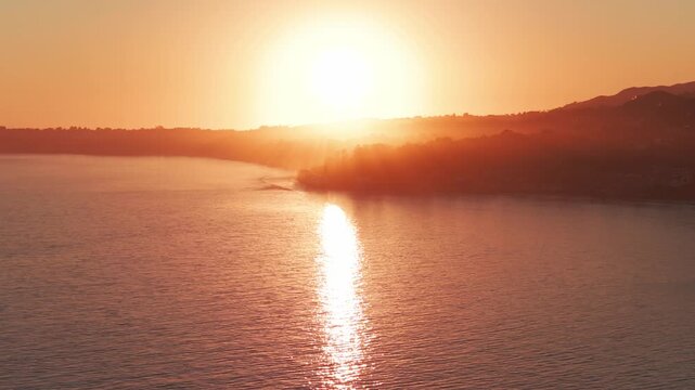 Aerial wide dolly shot of Point Dume at golden hour in Malibu, California. 4K