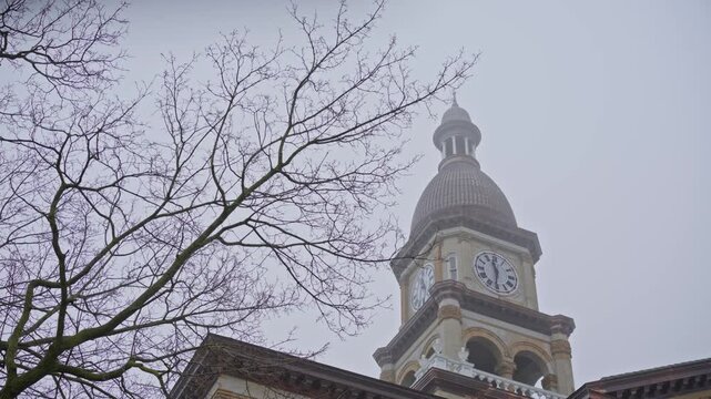 Cinematic right to left dolly shot of Hillsdale Michigan courthouse top architecture with detailed historic building exterior.