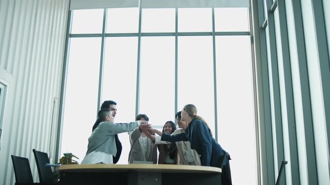Multiracial Businessperson united commitment partnership, synergy and harmony business company worker with solidarity strategy goal motivation, group of cheerful professional teamwork in firm meeting.