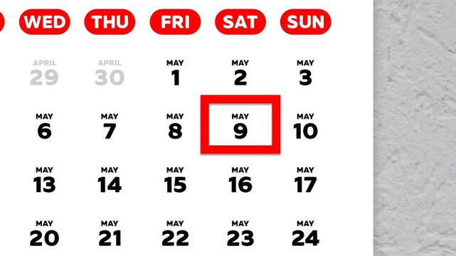 The date May 9th marked with a red cursor on the wall calendar 2026