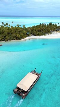 traditional style Polynesian boat cruise in lagoon, turquoise waters, tropical island