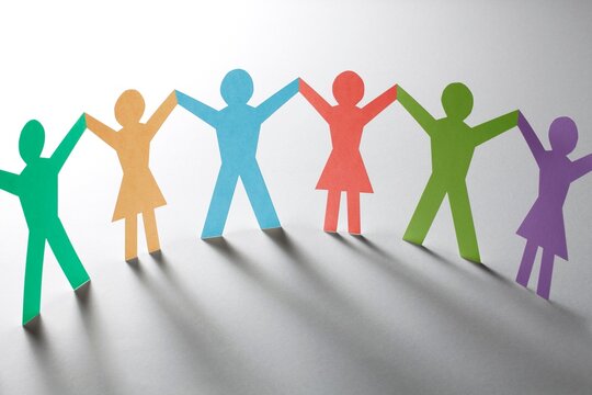 Diverse paper cutout people, colorful human figures, unity and teamwork concept, equality and diversity