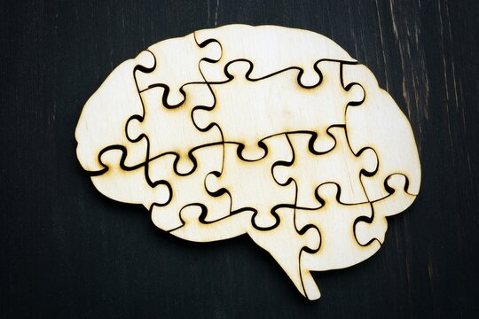 Jigsaw brain puzzle, wooden puzzle pieces, brain teaser, problem solving