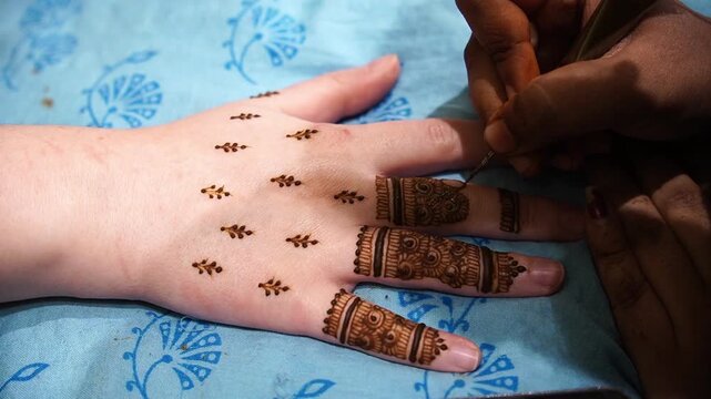 Intricate bridal Mehendi application: A professional henna artist creating detailed patterns on an Indian bride's hands during a traditional wedding ceremony.