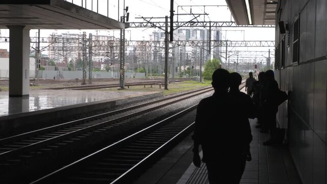 People waiting for a train at a station platform