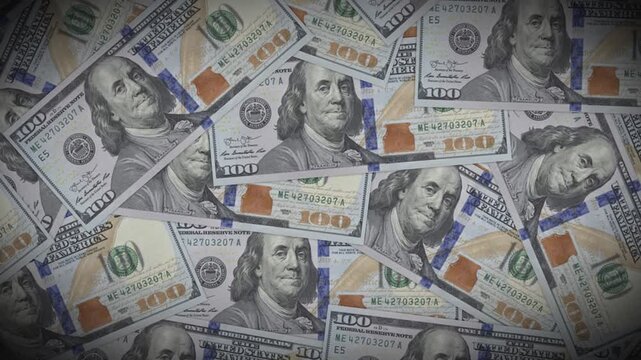 High-angle shot of scattered one hundred US dollar bills forming a dense pile of cash, symbolizing wealth, business success, and financial abundance.