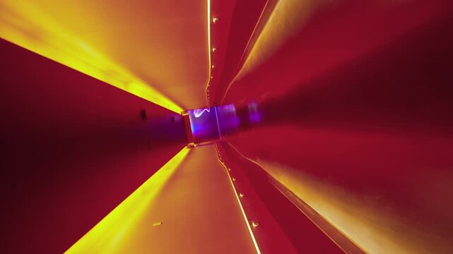 Abstract futuristic tunnel with vibrant red walls and bright yellow neon light beams converging toward a central purple glowing portal with ethereal white figure silhouette