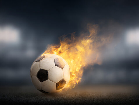 Soccer Ball on Fire with Flames in Stadium, Dramatic Football Sports Action Concept