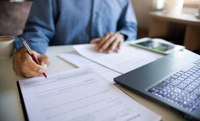 Naklejka premium close-up shot, businessman, professionals lawyers work on desk verify the accuracy of the document and checking business contracts before sign the documents