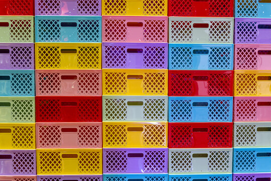 Stack of Colorful Plastic Crates Industrial Storage Containers. Ideal for industrial, warehouse, and organization concepts.