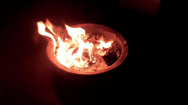 Burning paper trash in fireplace pit