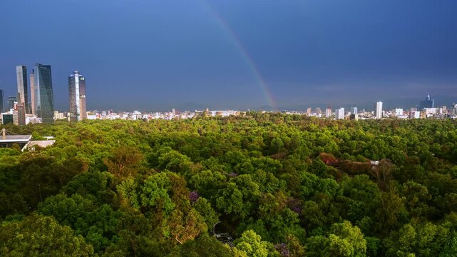 View of Mexico City's Chapultepec Forest and Reforma buildings with a rainbow in the background - 4K Video