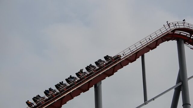 Roller Coaster Climbs High Into the Sky at Amusement Park