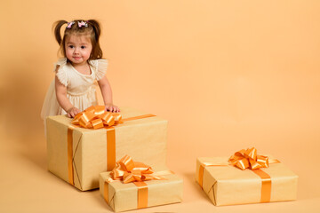 Baby holding gift box with cheerful expression. Cute kid celebrating birthday with festive mood....