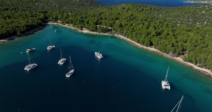 Aerial: Adriatic Sea with yachts during the day in Sibenik, Croatia, establishing drone shot