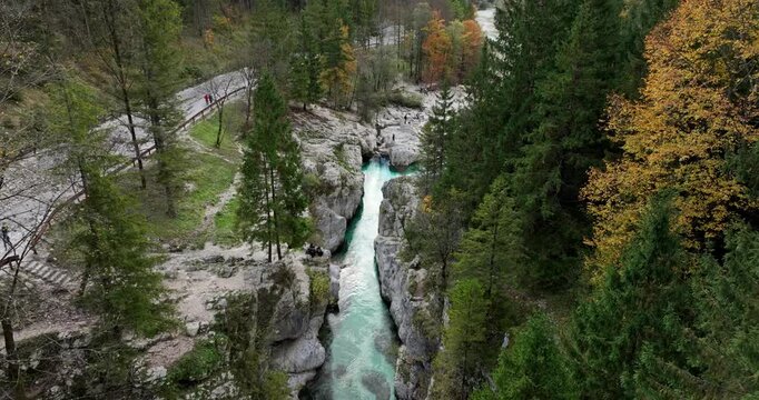 Aerial: alpine Soca River during the day in Bovec, Slovenia, establishing drone shot