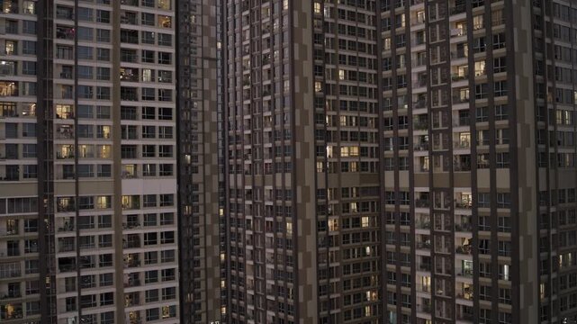 Towering Residential Skyscrapers With Illuminated Windows And Balconies At Dusk In Ho Chi Minh, Vietnam. elevated, static shot