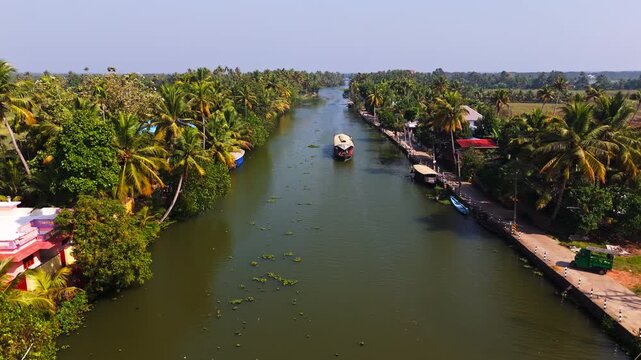 Aerial view rising in front of a Kettuvallam boat in waterways of South India
