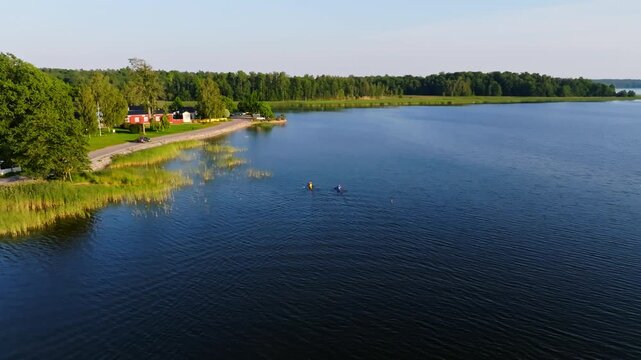 Aerial view of tourists kayaking on the coast of Ekenas city, summer in Finland