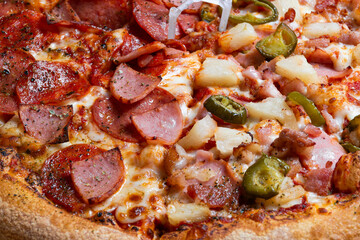 Overhead Fresh Delicious Pizza with Pepperoni, Ham, Pineapple and Jalapeno
