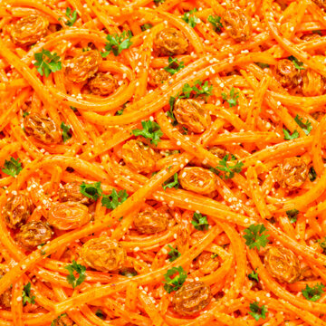 Fresh french carrot rappes salad with raisins sesame seeds and parsley