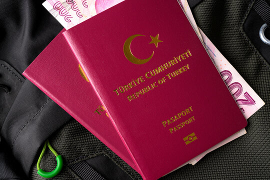 Turkish passport with cash money inside backpack symbolizing travel budget