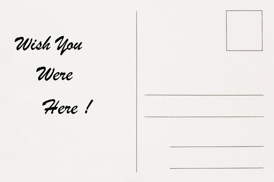 Postcard with wish you were here message handwritten background backdrop. Travel and holiday communication concept