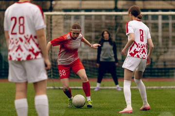 Fototapeta premium Young woman soccer players play football.
