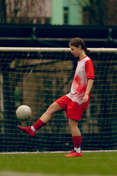Young woman soccer players play football.