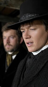 Mormon men, devout religious believers in traditional period garments, conveying faith, spiritual reflection, and a sense of historical community, pioneer heritage, early era